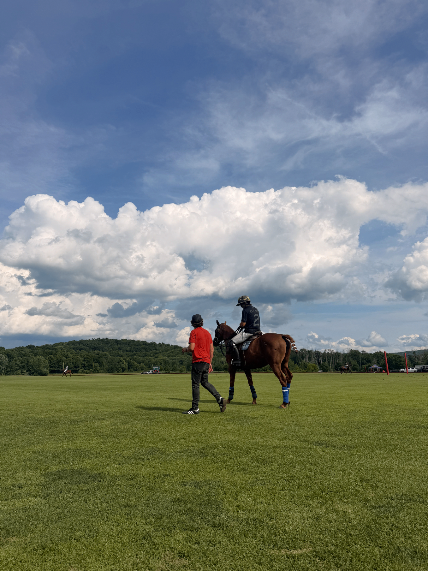 Polo player and coach on the field at Rosewater Ranch